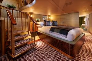 a bedroom with a large bed and a staircase at Fingal Hotel in Edinburgh