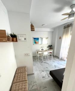 a living room and dining room with a table at Beach Side Heaven in Fuengirola +6 photos