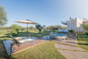 a patio with a bench and an umbrella and a pool at Villa Antheon in Kalamákion