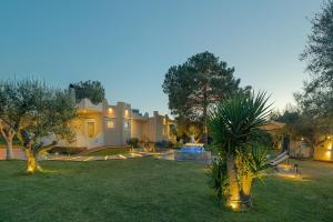 a house with a garden with a fountain in the yard at Villa Antheon in Kalamákion