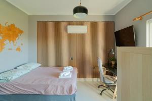 a bedroom with a bed and a desk and a chair at Villa Antheon in Kalamákion +23 photos
