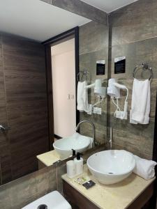 a bathroom with two sinks and a mirror at Hotel WLH Gold Bogota in Bogotá +94 photos