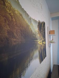a painting of a river on a wall at Ferienwohnung Lina in Nistertal