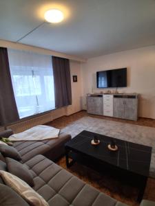 a living room with a couch and a coffee table at Ferienwohnung Lina in Nistertal