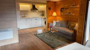 a living room with a couch and a table at Appartement vue panoramique in Binos