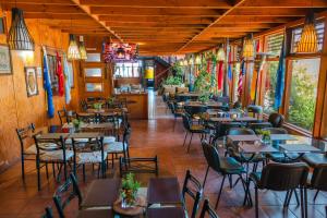 a restaurant with tables and chairs in a room at Hotel de la Costa in Talcahuano