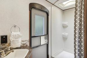 a bathroom with a sink and a shower at Perfect camper for your vacation in Ellenton +22 photos