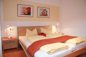 a bedroom with a large bed with two lamps on it at Ferienwohnungen Holder in Anhausen