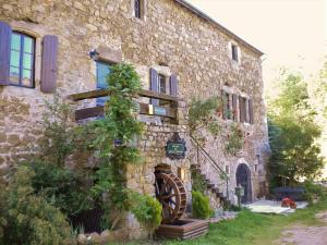 a stone building with a sign on the side of it at Chambres d'Hôtes Le Grand Chaleat in Éclassan