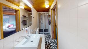 a bathroom with a sink and a mirror and a bedroom at Moving Rooms in Wimpassing +20 photos