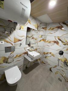 a bathroom with a mural of animals on the wall at Hotel Sahil - City Center, LalChowk in Srinagar