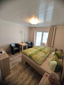 a bedroom with a bed and a living room with a table at Zingster Ostseeklause in Zingst +8 photos