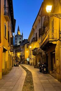 an empty street in a city at night at Il Cortiletto in Susa