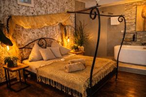 a bedroom with a bed and a tub and a sink at Ferienwohnung Time out in Vreden