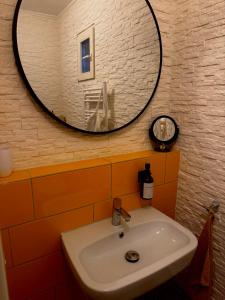 a bathroom with a sink and a mirror on the wall at Ferienwohnung Time out in Vreden