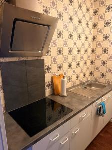 a kitchen with a sink and a stove at Ferienwohnung Time out in Vreden +9 photos