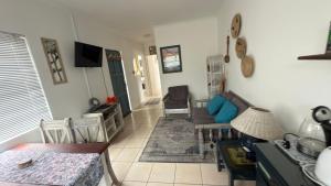 a living room with a couch and a table at Vicky holiday home in Walvis Bay