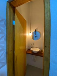 a bathroom with a white sink and a mirror at Refugio Aconchegante2 in Nova Mutum