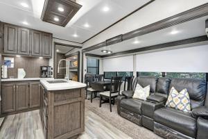 a kitchen and living room with a couch and a table at Roam sweet roam in Ellenton