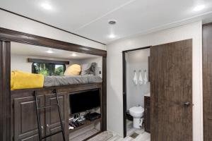 a small room with a bed and a toilet at Roam sweet roam in Ellenton +20 photos