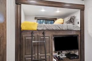 a mirror in a room with a bed and a tv at Roam sweet roam in Ellenton