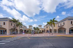 a street in a town with palm trees and buildings at Roam sweet roam in Ellenton