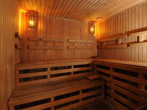 a wooden sauna with benches and lights in it at Windsor Hotel in Córdoba