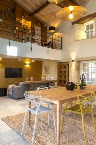a living room with a wooden table and chairs at Maison Girardine in Rauzan