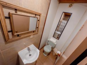 a bathroom with a sink and a toilet at Hotel de la Costa in Talcahuano