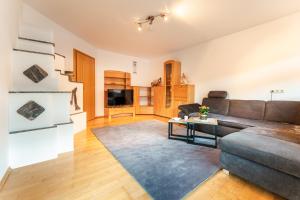 a living room with a couch and a table at Mountain Apex in Dölsach