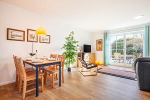 a dining room and living room with a table and chairs at Kira in Börzow