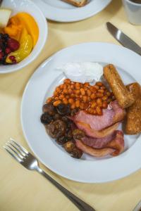 a plate of food with bacon beans and other foods at McIntosh Hall - Campus Accommodation in St. Andrews +11 photos