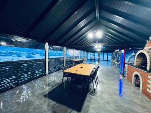 a dining room with a table and chairs in a building at Casa Pop in Petrova
