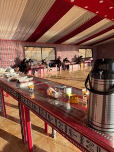 a room with a table with food on it at Wadi rum sky luxury in Disah