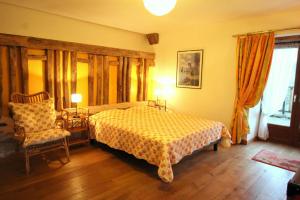 a bedroom with a bed and a chair at Leygat in Solignac +32 photos