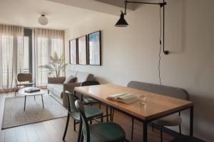 a living room with a table and a couch at Líbere Madrid Malasaña in Madrid