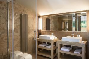 a bathroom with two sinks and a shower at Altarocca Wine Resort Adults Only in Orvieto