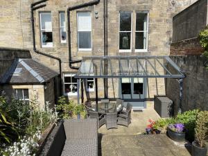 a patio with a table and chairs in front of a building at 7 Howard Place in St. Andrews