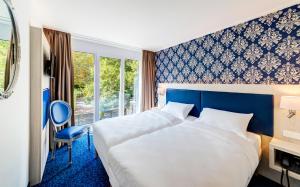 Postel nebo postele na pokoji v ubytování ibis Styles Rastatt Baden-Baden