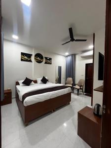 a bedroom with a bed and a living room at Mayura palace in Jaipur