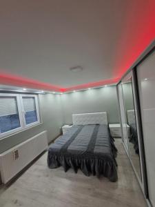 a bed in a small room with a red ceiling at PODNOZJe KOPAONIKA in Brus