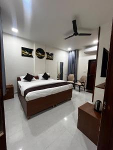 a bedroom with a bed and a living room at Mayura palace in Jaipur
