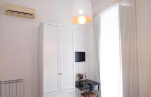 a room with a white cabinet and a television at La Locanda del Baffo in Capua