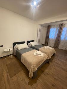 a bedroom with two beds and a table and a window at Sweet House in Solesino +18 photos