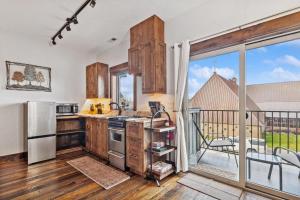 a kitchen with wooden cabinets and a large window at Bliss Retreat in Whitefish