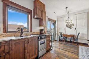 a kitchen with a sink and a stove top oven at Bliss Retreat in Whitefish +9 photos