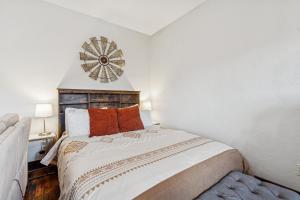 a bedroom with a bed and a clock on the wall at Bliss Retreat in Whitefish