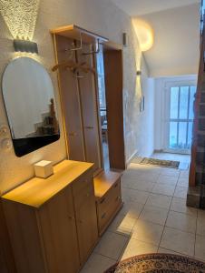 a bathroom with a mirror and a wooden dresser at Ferienhaus "Fritz" mit 3 Schlafzimmern in Seenähe in Löbnitz
