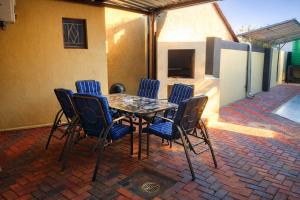 a table and chairs on a brick patio at Joyful Home Bela-Bela in Bela-Bela