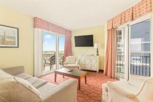 a living room with a couch and a tv at Bay View Resort 1202 in Myrtle Beach